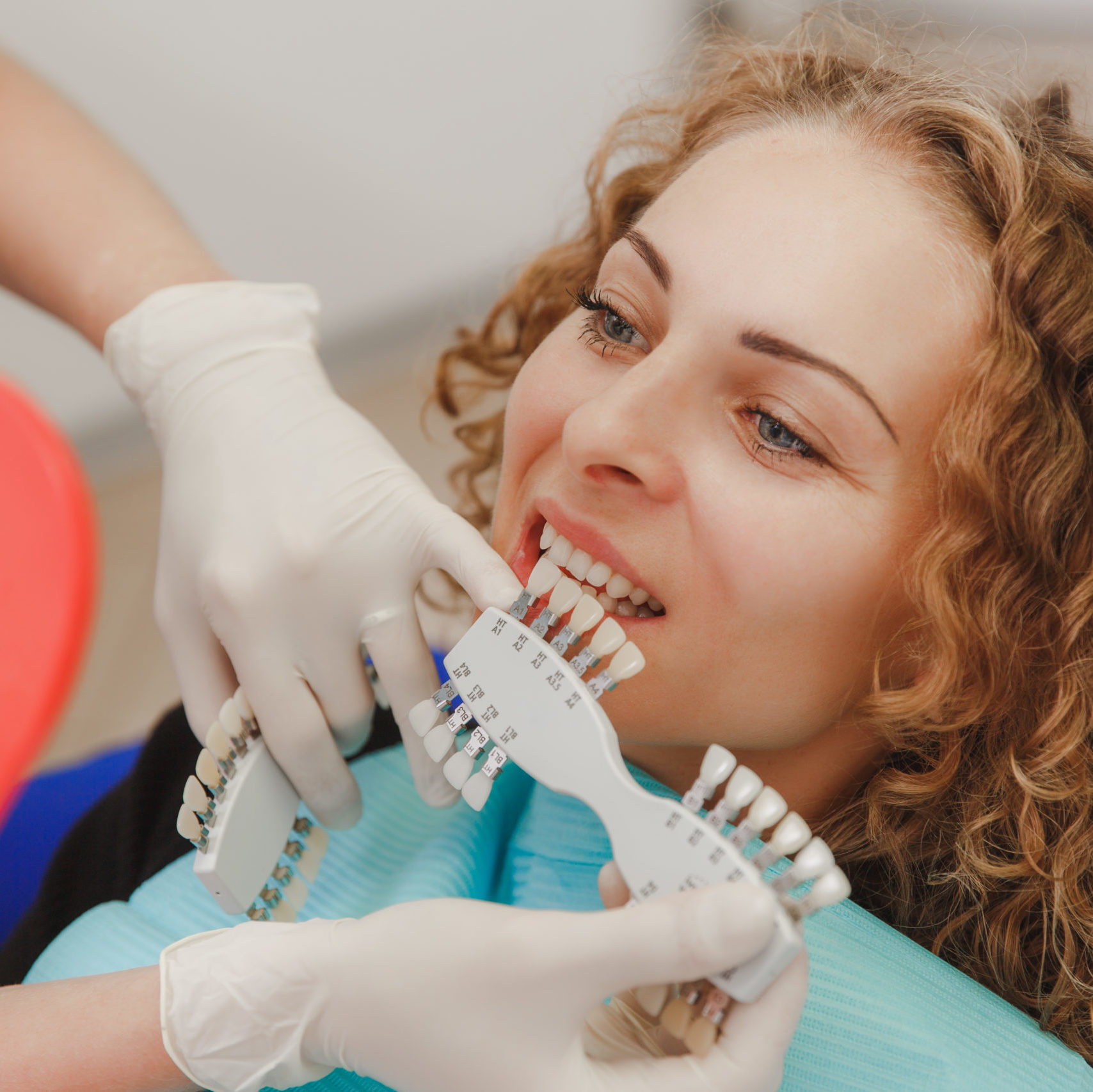 cropped dentist comparing patient s teeth shade with samples bleaching treatment scaled 2 - Front Page